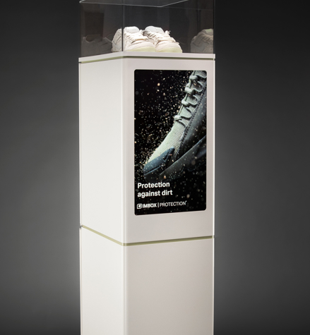 Front view of white IMBOX Flagship with display and sneakers on top