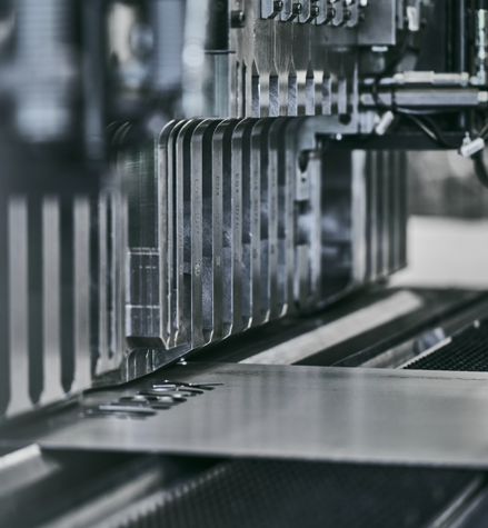 Close-up of an industrial machine working on a metal sheet