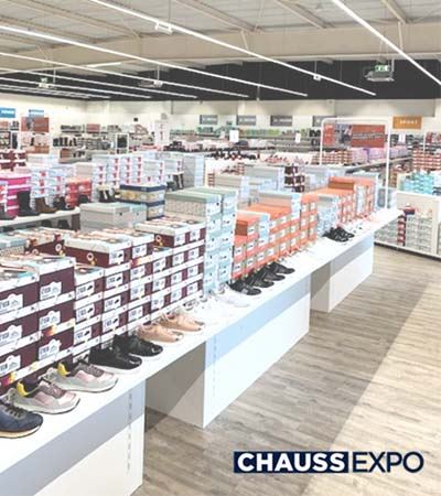 View inside of Chaussexpo store with shoes placed on shoe tables