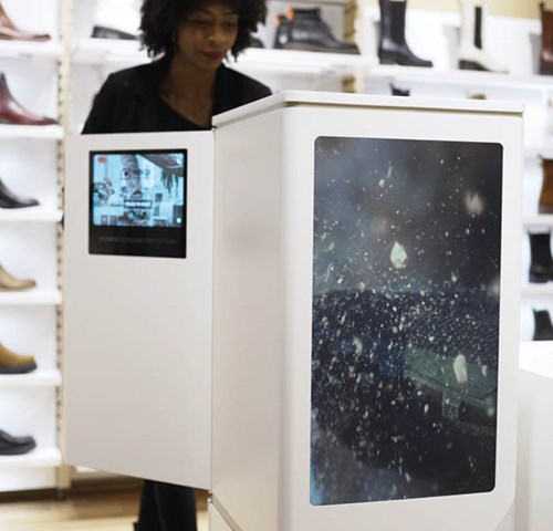 A woman uses the Imbox Flagship protection solution in a footwear store