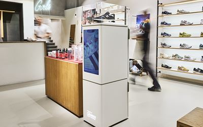 IMBOX Flagship standing in shoe store next to the counter
