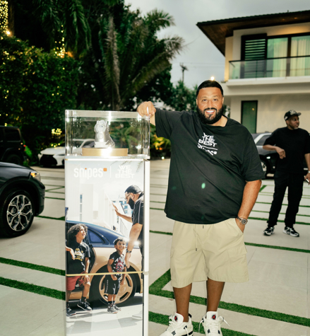 DJ Khaled standing next to an exclusive and a custom IMBOX Flagship