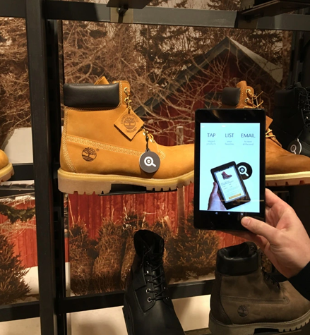 Customer finding digital info about Timberland boots in Timberland store