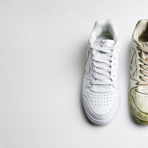 Clean and dirty white sneakers placed next to each other