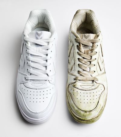 Clean and dirty white sneakers standing next to each other