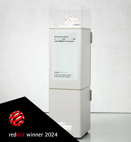 White IMBOX Flagship with white sneakers with white and red Red Dot Award Product Design Winner 2024 logo