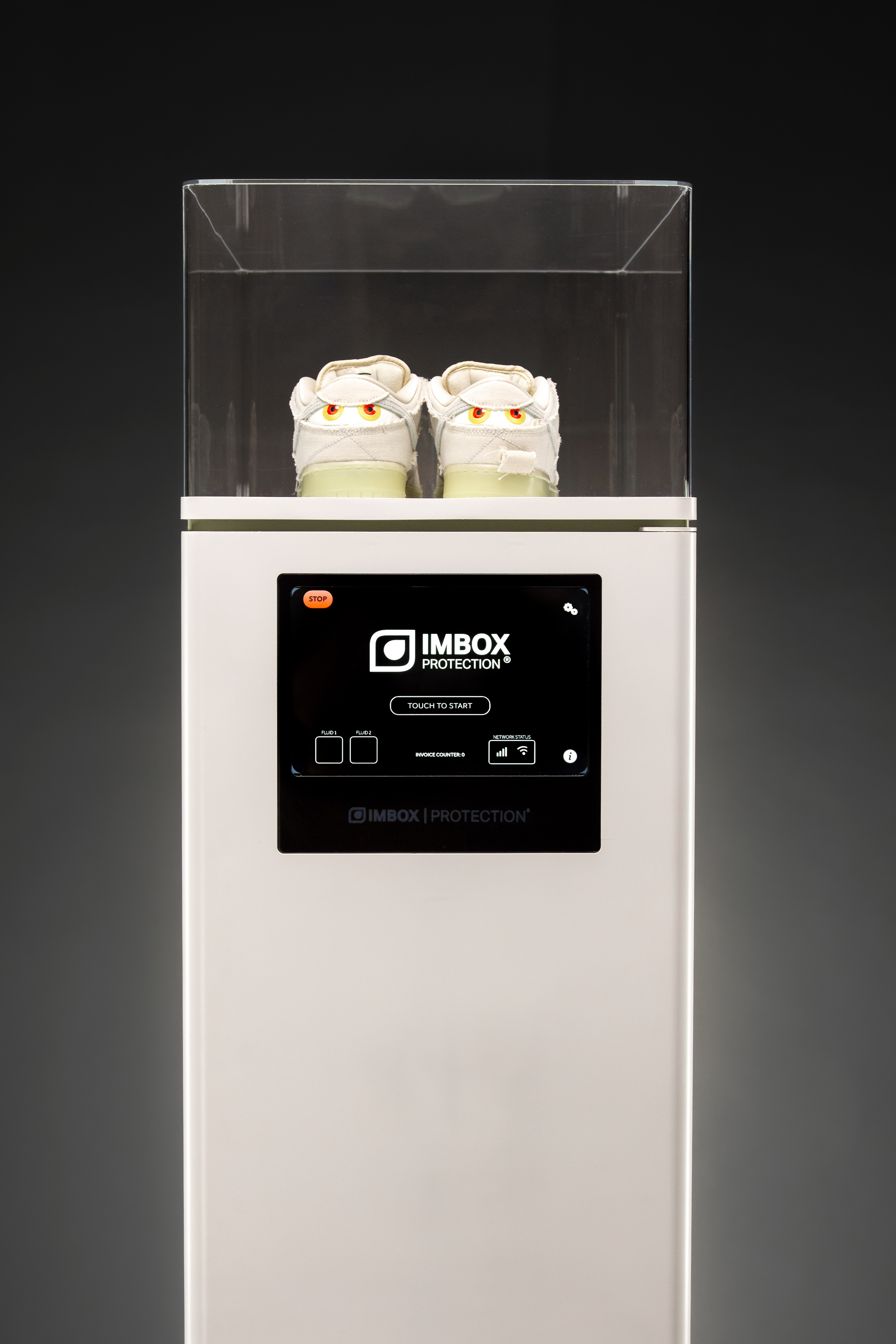 Front view of white IMBOX Flagship with display and sneakers on top