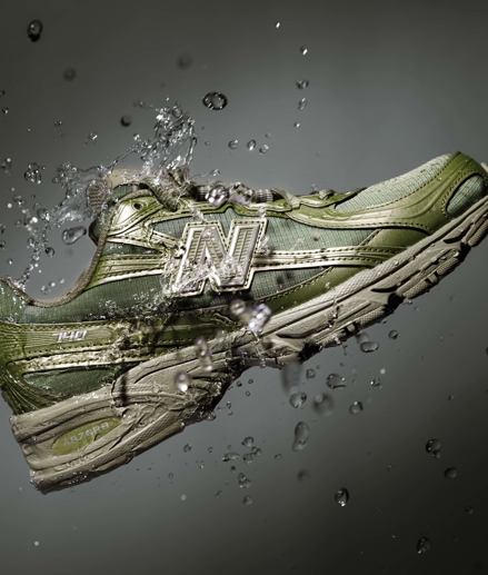 Green New Balance sneaker with water
