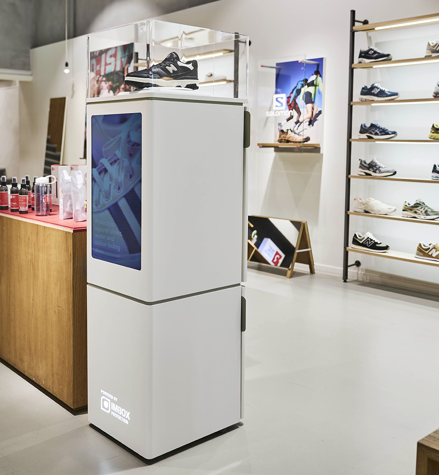 IMBOX Flagship standing in shoe store next to cashier 