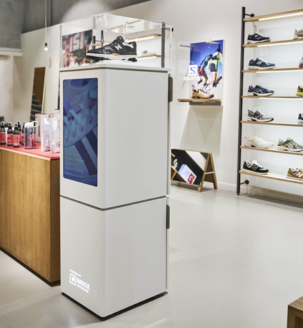 IMBOX Flagship standing in shoe store next to cashier