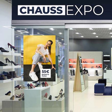Front view of Chaussexpo store with poster in the display and shoes on racks 