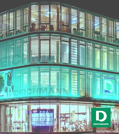 View of Deichmann store in four levels with green and white Deichmann logo