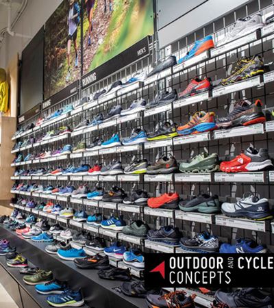 View of Outdoor and Cycle Concept store of shoe racks filled with coloured shoes with black and white logo